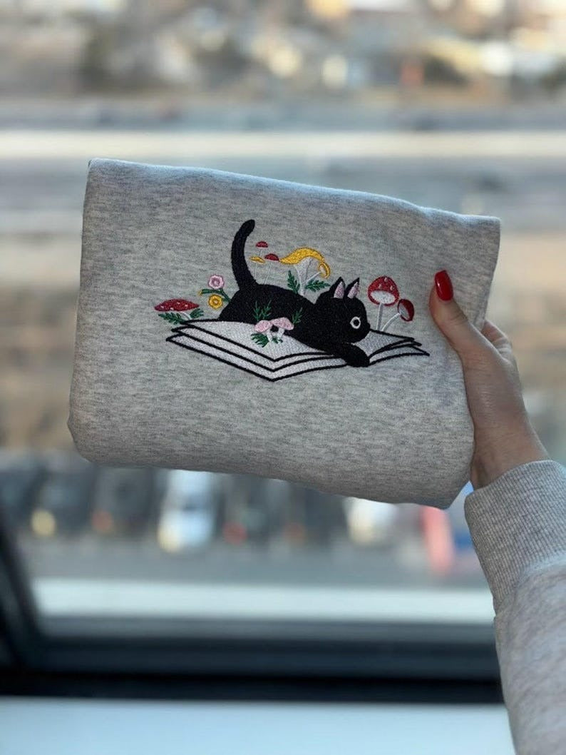 EMBROIDERED Cute Cat On Book Sweatshirt, Daisy and Mushroom Floral, Librarian Sweatshirt, Bookish Sweatshirt, Cat Book Sweatshirt